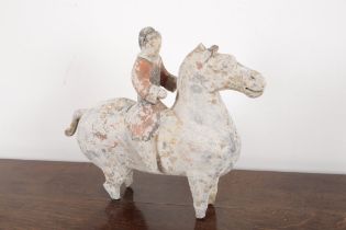 A CHINESE POTTERY GROUP OF HORSE AND RIDER