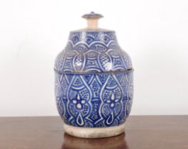 A PERSIAN TERRACOTTA VASE AND COVER