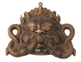 A CHINESE BROWN PATINATED BRONZE GARUDA DOOR MOUNT