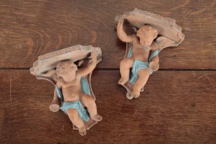 A PAIR OF ITALIAN TERRACOTTA WALL APPLIQUE