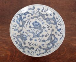 A CHINESE PORCELAIN BLUE AND WHITE 'DRAGON' DISH