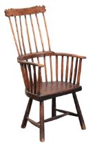 A PRIMITIVE WELSH ELM AND ASH COMB BACK ARMCHAIR