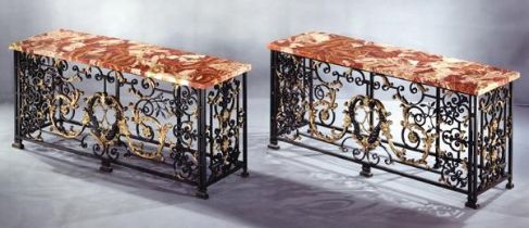 AN IMPORTANT PAIR OF REGENCE WROUGHT IRON AND GILT CONSOLE TABLES