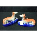 A PAIR OF STAFFORDSHIRE POTTERY GREYHOUND INKWELLS