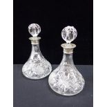 A PAIR OF SILVER COLLARED SHIP'S DECANTERS