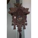 A GERMAN CUCKOO CLOCK, WITH CARVED CASE