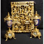 A PAIR OF GILT METAL AND PORCELAIN GARNITURE