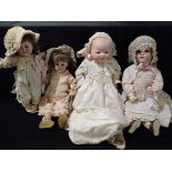 FOUR VARIOUS BISQUE HEAD DOLLS