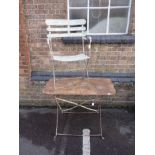 AN IRON GARDEN TABLE, AND SIMILAR ARMCHAIR