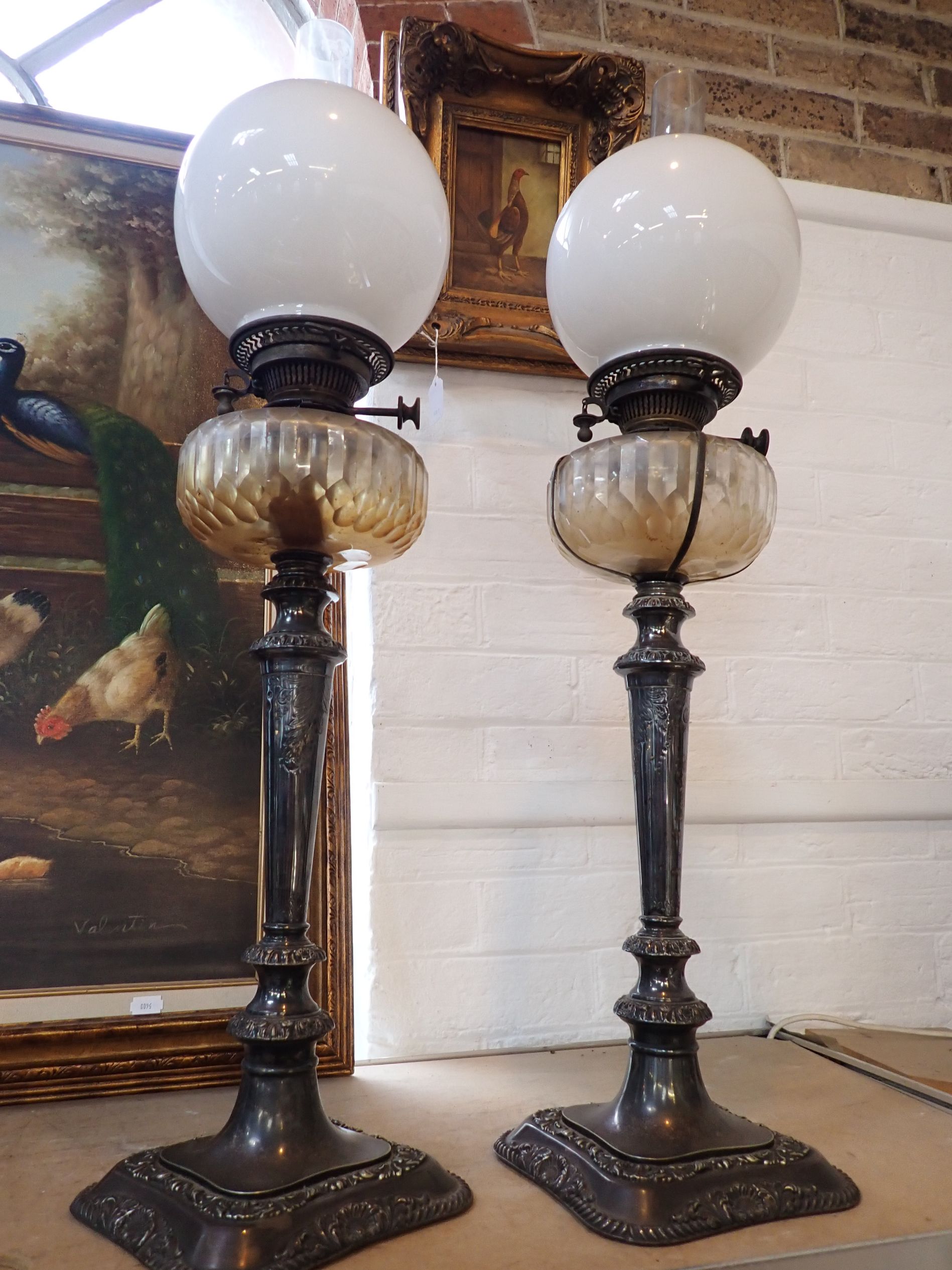 A PAIR OF VICTORIAN SILVER-PLATED OIL LAMPS