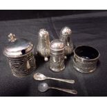 A PAIR OF SILVER GADROONED PEPPER POTS