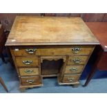 A GEORGE I STYLE FIGURED WALNUT KNEEHOLE DRESSING TABLE