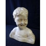 A PLASTER BUST OF A SMILING CHILD