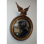 A CONVEX WALL MIRROR WITH EAGLE SURMOUNT