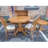 A MODERN OAK CIRCULAR DINING TABLE AND CHAIRS