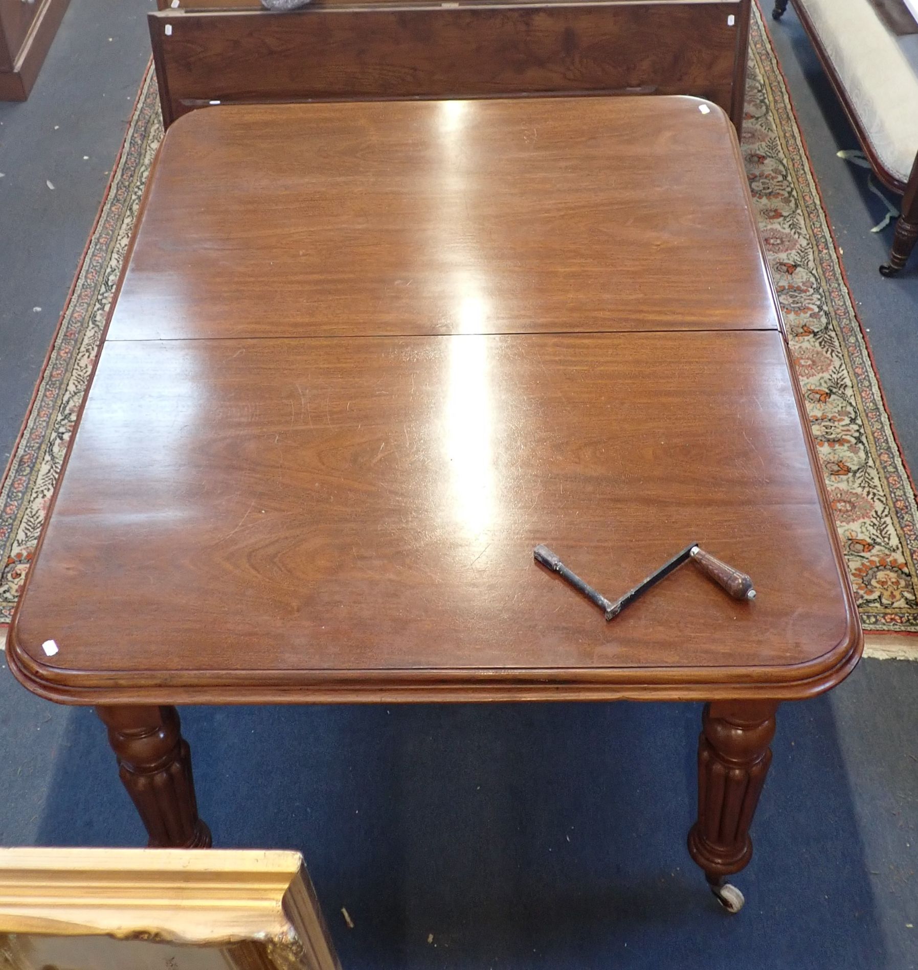 A VICTORIAN MAHOGANY EXTENDING DINING TABLE