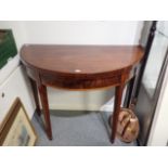 A GEORGE III FIGURED MAHOGANY SEMI CIRCULAR CARD TABLE