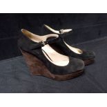 PRADA: A PAIR OF BLACK AND BROWN SUEDE WEDGE HEEL SHOES