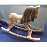 A CARVED LAMINATED WOOD ROCKING HORSE