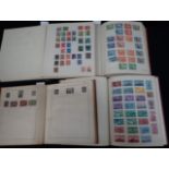 FOUR ALBUMS OF MIXED UK AND FOREIGN STAMPS
