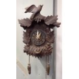 AN OLD BLACK FOREST WALL CLOCK