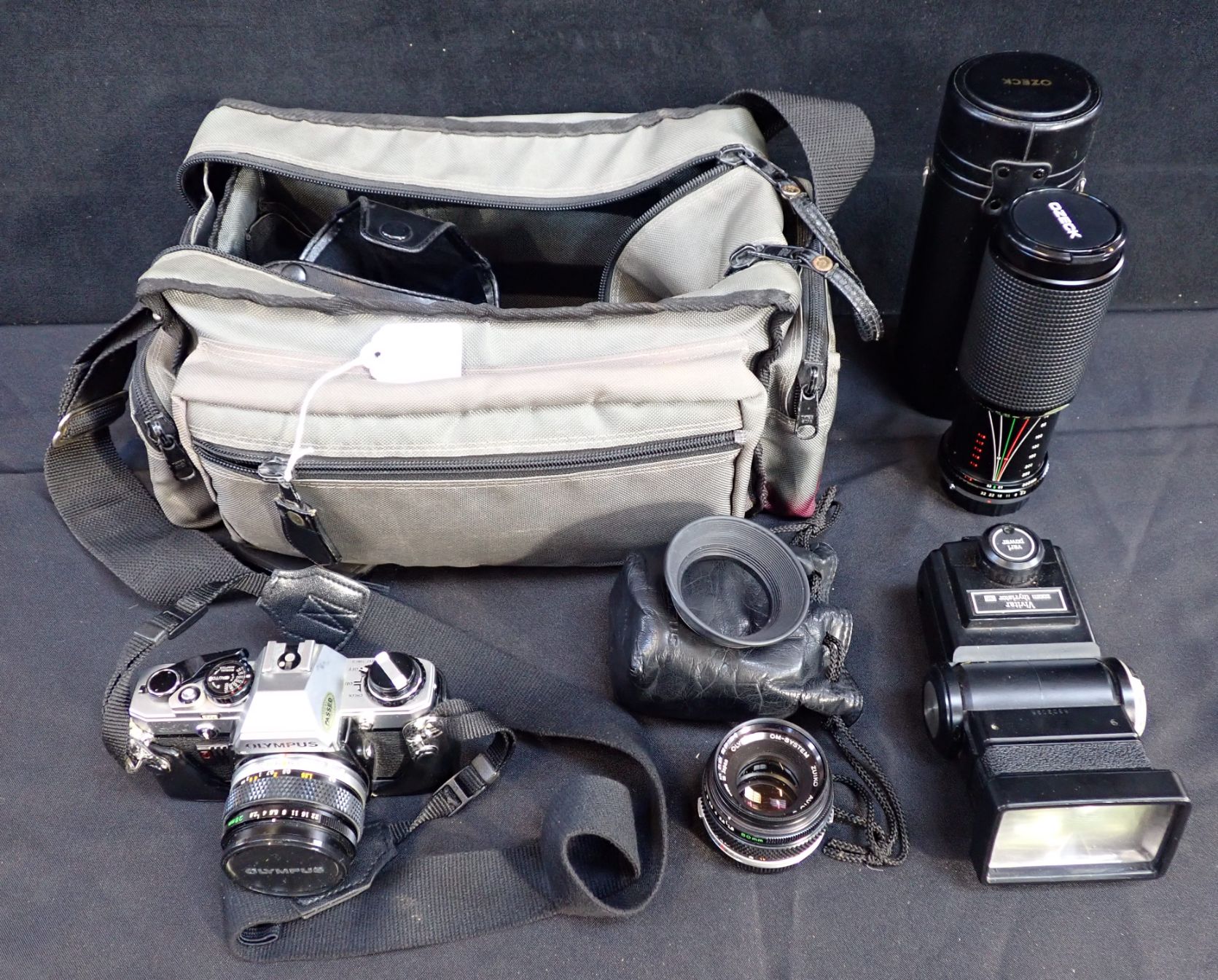 AN OLYMPUS CM10 35MM SLR CAMERA together with an Ozeck 75-300mm lens ...