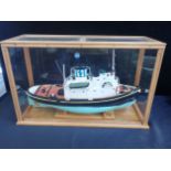 A CASED MODEL OF A TUG