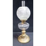 A 19TH CENTURY BRASS TABLE OIL LAMP WITH CLEAR GLASS RESERVOIR AND SHADE