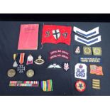 A COLLECTION OF MILITARY BADGES AND MEDALS