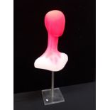 A PINK PAINTED PLASTIC DISPLAY HEAD