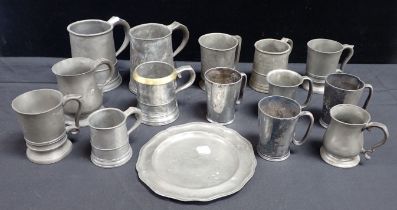 A COLLECTION OF PEWTER PUB TANKARDS AND MEASURES
