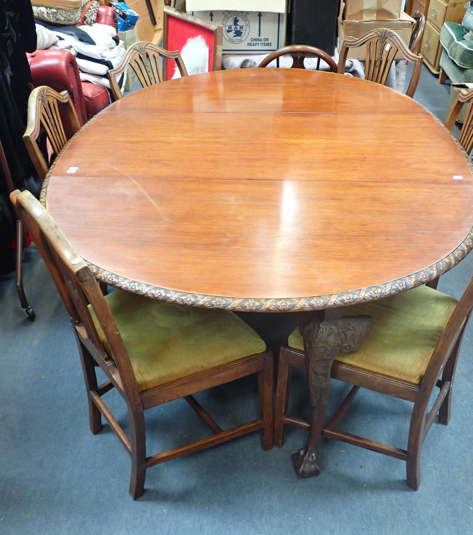 A DROP LEAF OVAL MAHOGANY TABLE