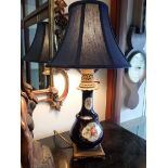 A FRENCH CERAMIC AND SPELTER TABLE LAMP