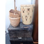 A WICKER BASKET ON WHEELS, A LAUNDRY BASKET