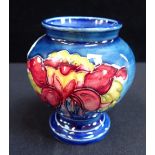 MOORCROFT: AN ORCHID DECORATED SQUAT VASE