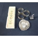 THREE SILVER NAPKIN RINGS, A SILVER DISH