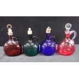 FOUR VICTORIAN COLOURED GLASS DECANTERS