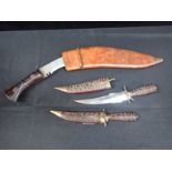 A KUKRI, POSSIBLY NEPALESE, IN LEATHER SCABBARD