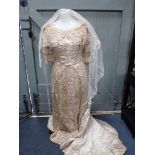A LATE VICTORIAN SILK WEDDING DRESS, WITH LACE COLLAR AND PANELS