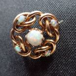A 15CT YELLOW GOLD AND OPAL KNOT BROOCH