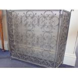 A WROUGHT IRON AND MESH FIRE SCREEN, OF TRIPTYCH FORM