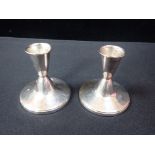 A PAIR OF SHORT SILVER CANDLESTICKS