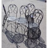 A SET OF SIX SCROLLING WROUGHT METAL GARDEN CHAIRS