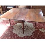 A GEORGE II STYLE MAHOGANY DROP LEAF DINING TABLE