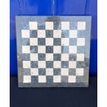 A POLISHED PURBECK STONE CHESSBOARD, BY HAYSOM