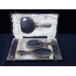 A SILVER MOUNTED TORTOISESHELL DRESSING TABLE SET