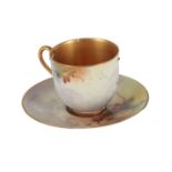 A ROYAL WORCESTER BONE CHINA 'PEACOCK' CABINET CUP AND SAUCER BY SEAGLEY