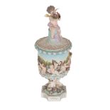 AN EARLY 20TH CENTURY GERMAN PORCELAIN LIDDED URN, POSSIBLY VOLKSTEDT