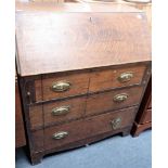 A GEORGE III OAK BUREAU OF SMALL PROPORTIONS