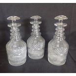 A SET OF THREE GEORGIAN CUT GLASS DECANTERS